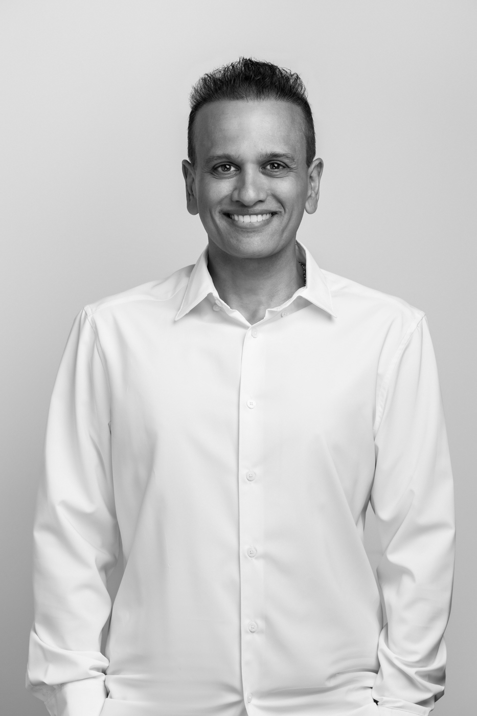 Black and white portrait of Vijay Raghvani in a white shirt